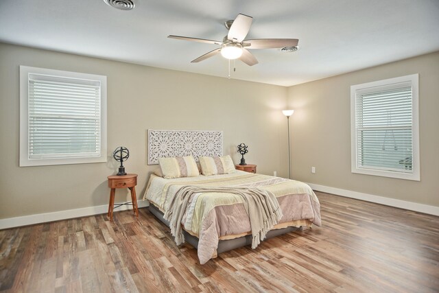 bedroom with ceiling fan and hardwood / wood-style flooring