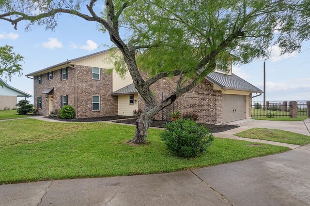 view of front of home with a front lawn and a garage