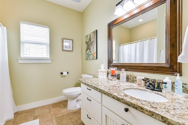 bathroom with vanity, toilet, and tile patterned floors