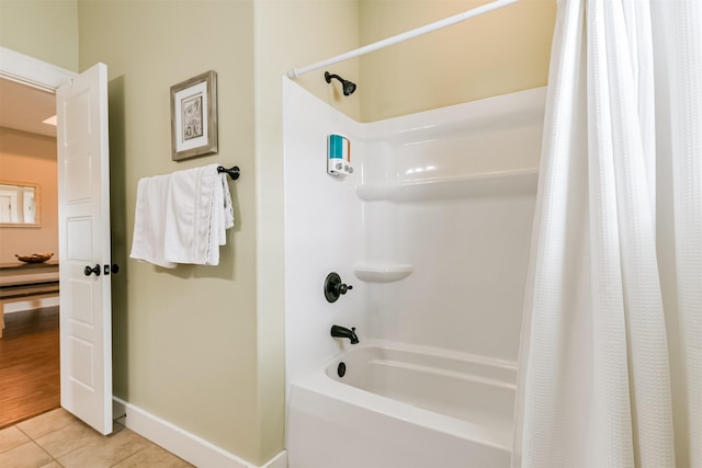 bathroom with shower / bath combination with curtain and tile patterned floors