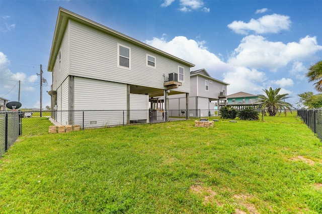 rear view of house featuring a fire pit and a yard