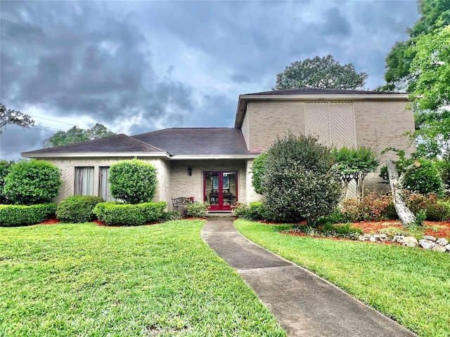 view of front facade featuring a front yard and french doors