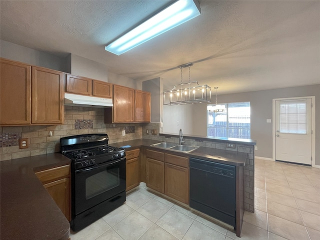 kitchen featuring kitchen peninsula, black appliances, sink, a chandelier, and pendant lighting