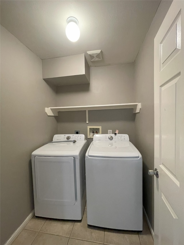 laundry room featuring washer hookup, separate washer and dryer, light tile floors, and hookup for an electric dryer