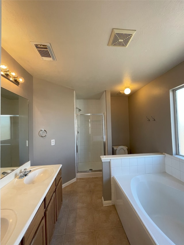 bathroom with tile flooring, separate shower and tub, double sink, and oversized vanity