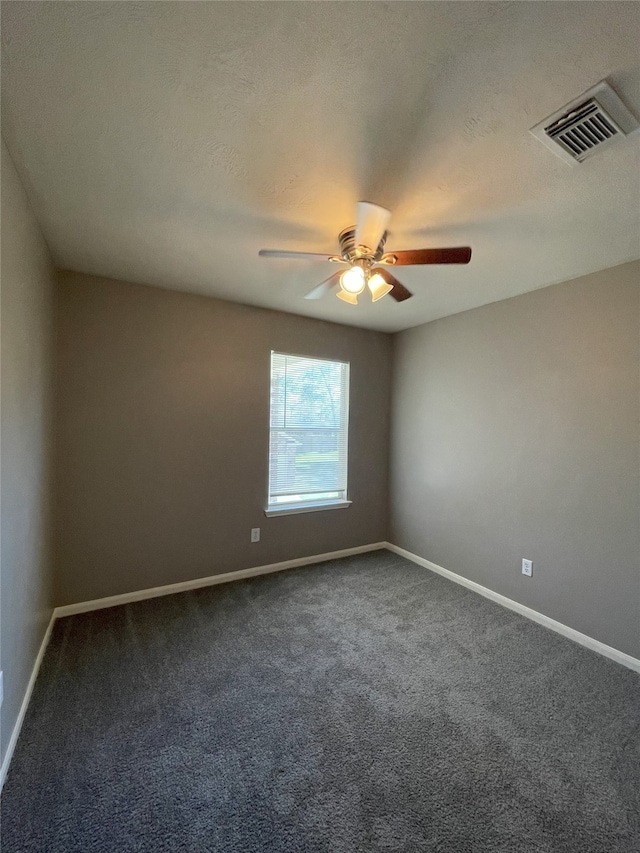 unfurnished room featuring ceiling fan and dark carpet