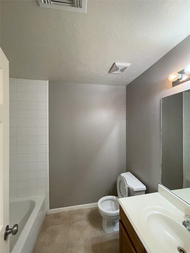 full bathroom featuring vanity, tile floors, shower / bathing tub combination, a textured ceiling, and toilet