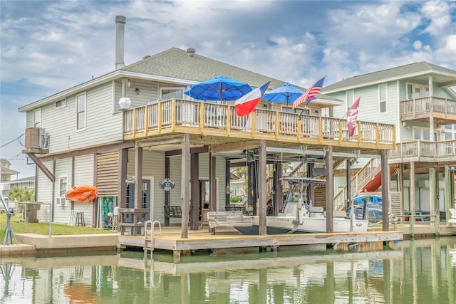 rear view of property featuring a deck with water view