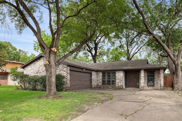 ranch-style home featuring a garage and a front lawn