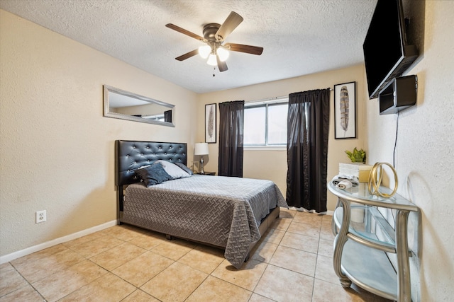 bedroom with ceiling fan, a textured ceiling, and light tile floors