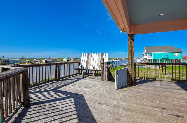 wooden terrace featuring a water view