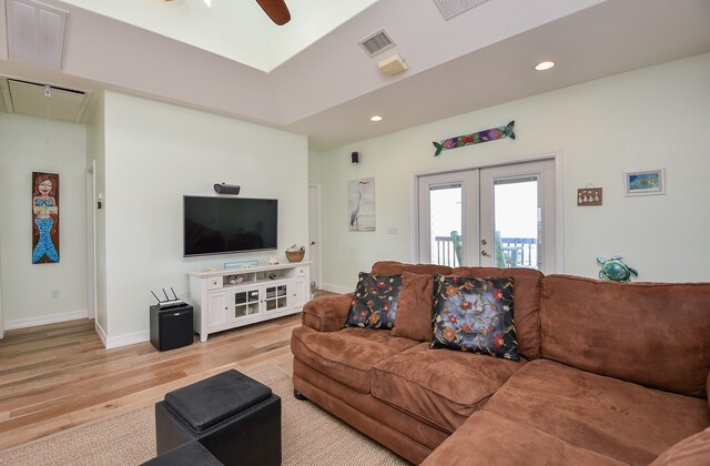 living room featuring light hardwood / wood-style flooring, french doors, and ceiling fan