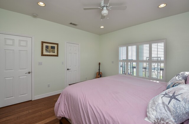 bedroom featuring ceiling fan and dark wood-type flooring