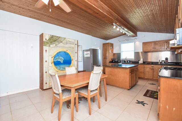 tiled dining room with lofted ceiling with beams, rail lighting, sink, wood ceiling, and ceiling fan