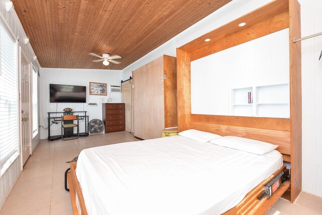 bedroom featuring wood ceiling, a barn door, ceiling fan, and light tile floors