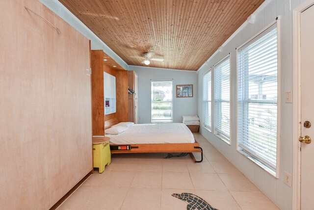 tiled bedroom featuring wooden ceiling and vaulted ceiling