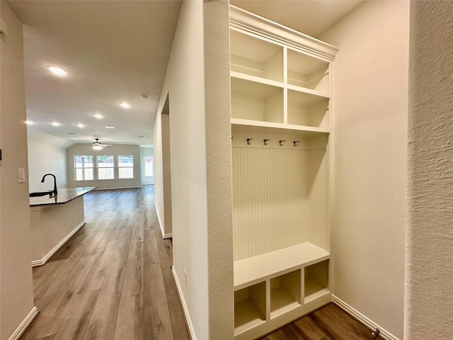 mudroom with wood-type flooring, ceiling fan, and sink