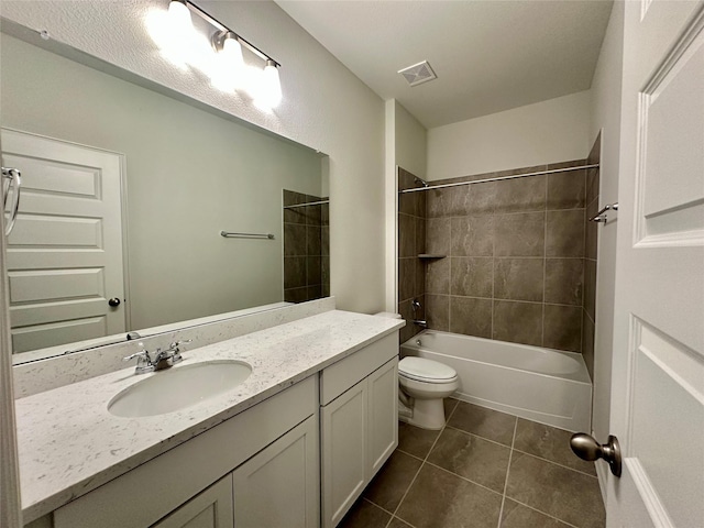 full bathroom with tile patterned floors, toilet, vanity, and tiled shower / bath