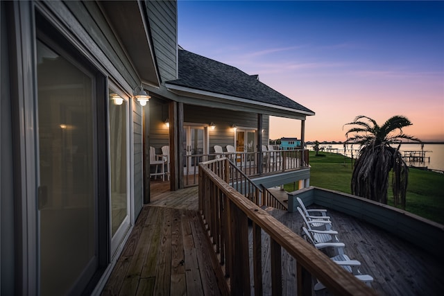 deck at dusk with a lawn