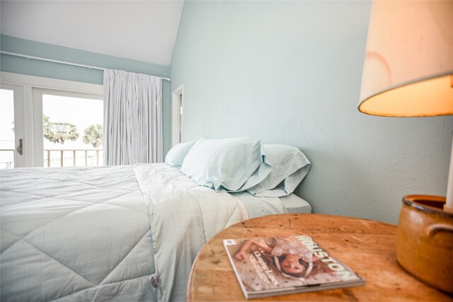 bedroom with access to exterior and vaulted ceiling