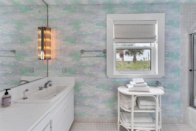 bathroom featuring enclosed tub / shower combo, vanity, and tile floors