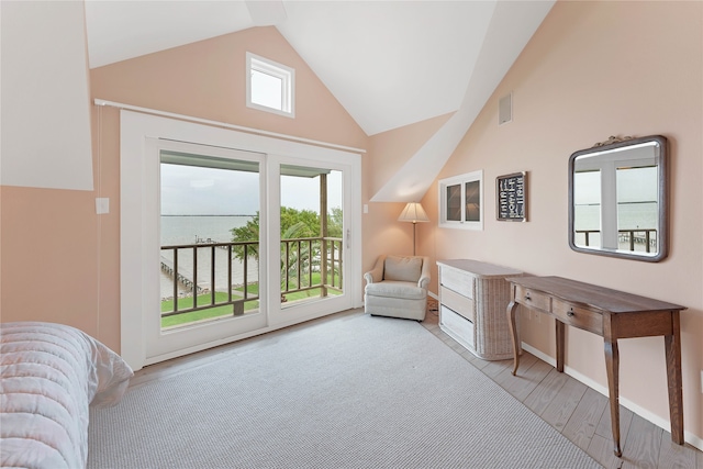 living area with light wood-type flooring, plenty of natural light, and high vaulted ceiling