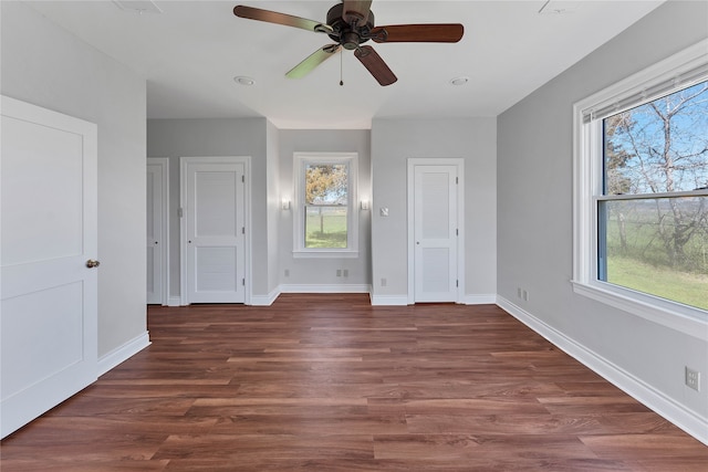 unfurnished bedroom featuring ceiling fan and dark hardwood / wood-style flooring