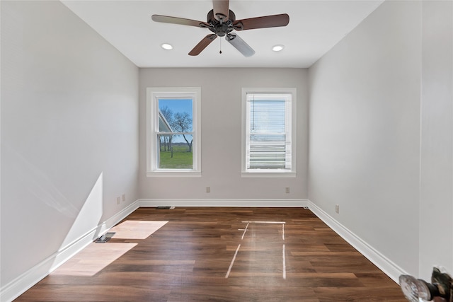 spare room featuring ceiling fan and dark hardwood / wood-style flooring