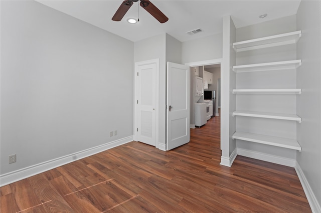 unfurnished bedroom with ceiling fan and dark wood-type flooring