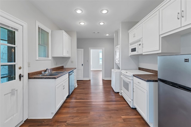 kitchen featuring dark hardwood / wood-style floors, white cabinetry, appliances with stainless steel finishes, and sink