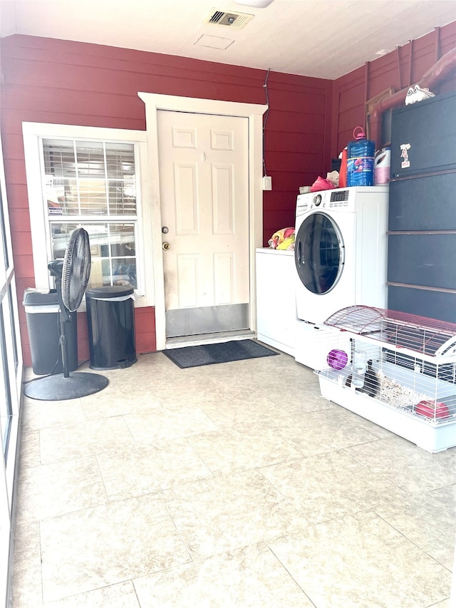 washroom with washer / dryer and tile floors