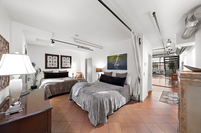 tiled bedroom featuring rail lighting