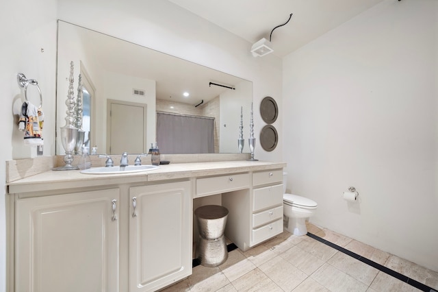 bathroom with tile floors, toilet, and vanity