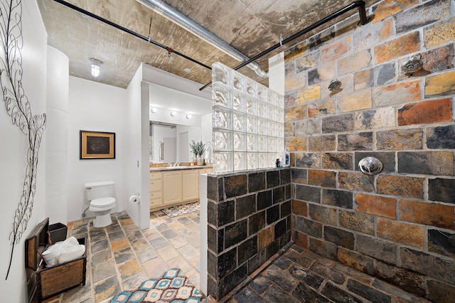 bathroom featuring toilet and vanity