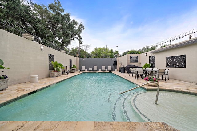 view of swimming pool with a patio area