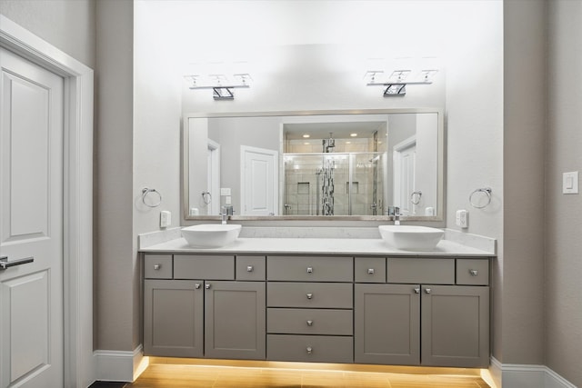 bathroom featuring walk in shower, vanity, and hardwood / wood-style floors