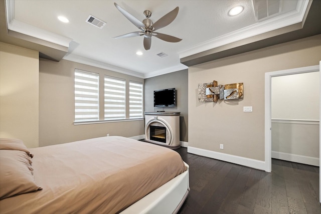 bedroom featuring dark hardwood / wood-style flooring, crown molding, and ceiling fan