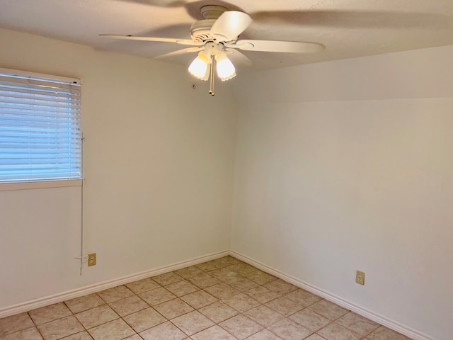 empty room with light tile floors and ceiling fan