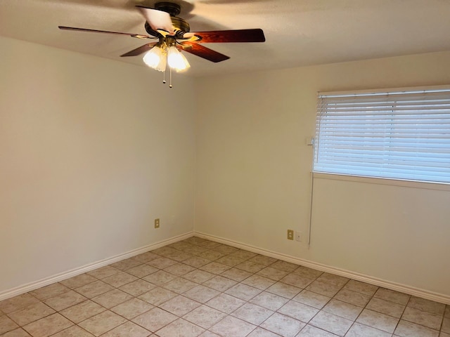 spare room featuring ceiling fan and light tile flooring