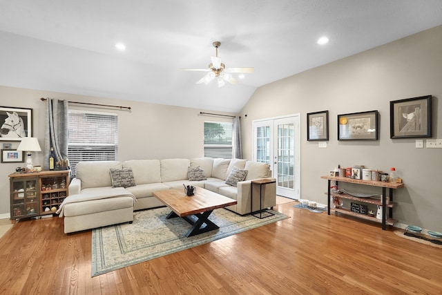 living room with french doors, light hardwood / wood-style flooring, ceiling fan, and lofted ceiling