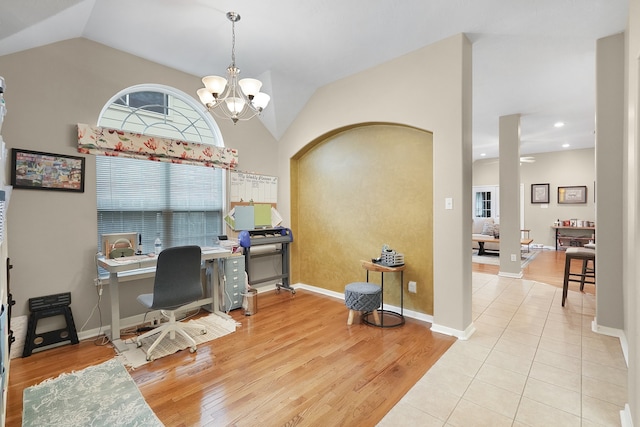 home office featuring light tile flooring, an inviting chandelier, a wealth of natural light, and lofted ceiling