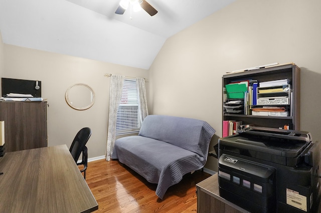 home office with ceiling fan, light hardwood / wood-style flooring, and vaulted ceiling