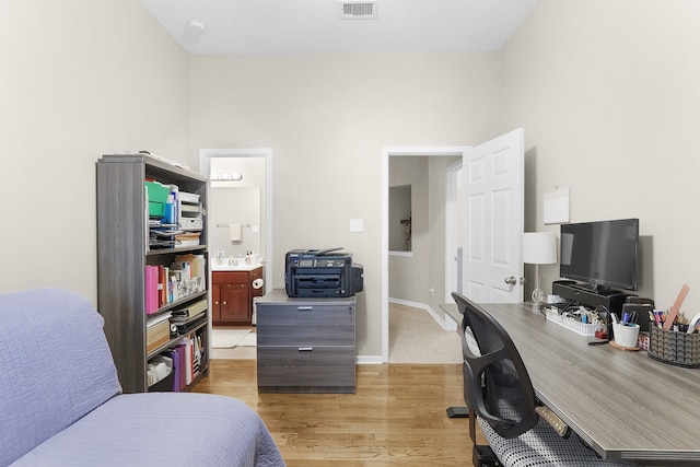 interior space featuring light hardwood / wood-style flooring and ensuite bathroom