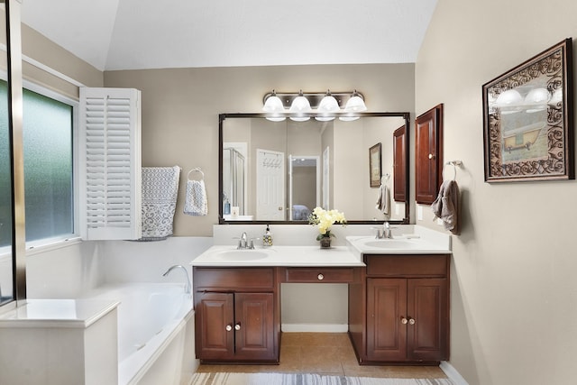 bathroom featuring tile flooring, double vanity, vaulted ceiling, and a washtub