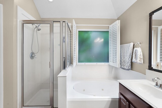 bathroom with independent shower and bath, vanity, and lofted ceiling