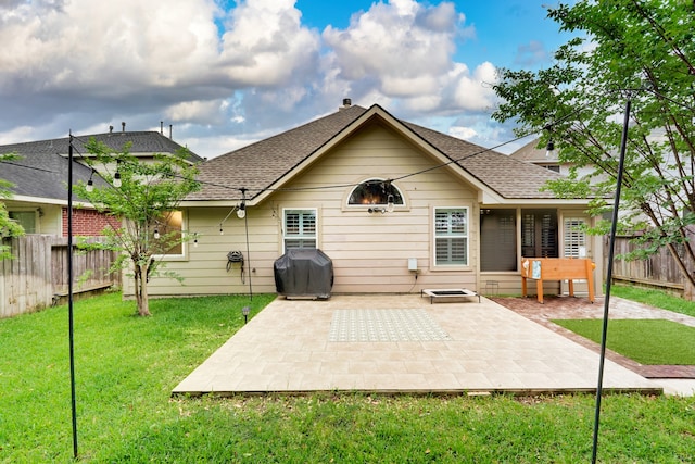 rear view of property with a patio and a lawn