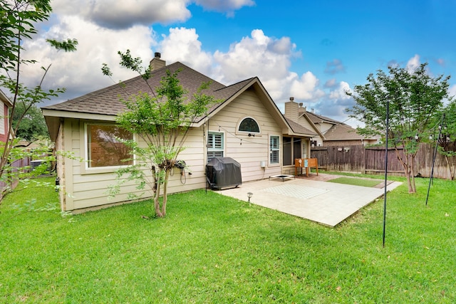 rear view of house featuring a patio area and a lawn