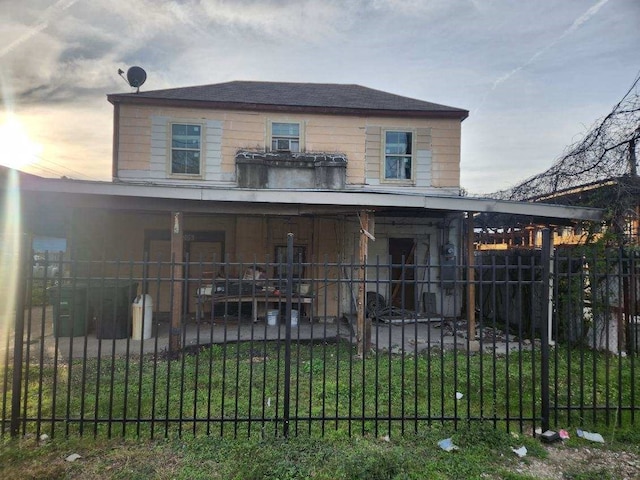 view of front of house with a patio area and a yard