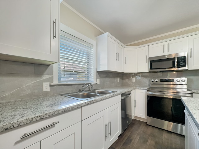 kitchen featuring stainless steel appliances, backsplash, dark hardwood / wood-style flooring, sink, and white cabinets