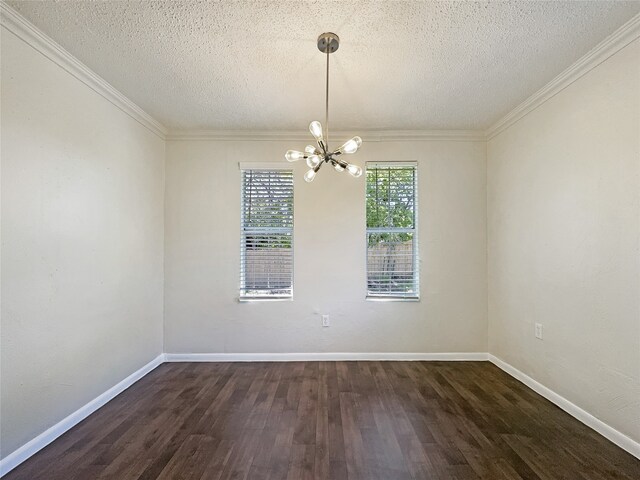 spare room featuring dark hardwood / wood-style flooring, a notable chandelier, ornamental molding, and a textured ceiling